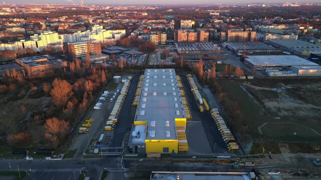 Long yellow DHL distribution center Berlin. Magic aerial view flight drone