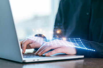 Digital innovation in action as a person works on a laptop with data visualization above the keyboard