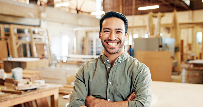 Man, carpenter and arms crossed in portrait at workshop with pride, smile and furniture manufacturing. Person, small business owner and happy with woodwork, craft or excited at factory in Indonesia