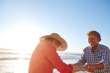 Laughing, mature couple and dancing on beach for anniversary date, travel adventure and flare. Love, happy people or holding hands with movement at ocean for romantic holiday, bonding or mockup space