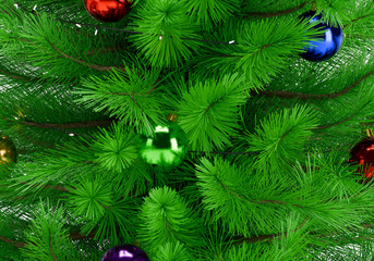 Close up of a perfectly decorated Christmas tree with balls on a white background