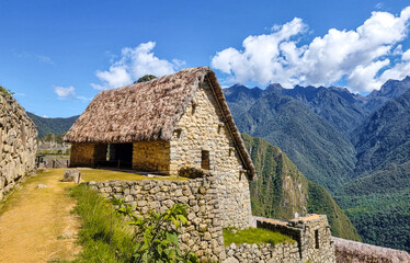 A reconstructed Inca house in Machu Picchu, Peru. This traditional stone structure, with its thatched roof, represents the ancient architecture of the Inca civilization.
