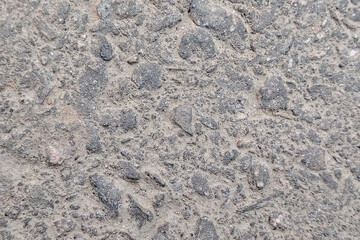 Close up of rough grey asphalt texture with small stones