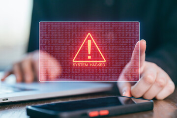 Security alert on a computer screen indicating a system hack during late work hours at an office