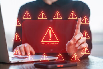 Computer hacker warning with alerts displayed on screen and a person interacting in an office setting