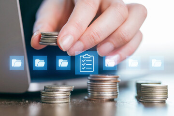 Stacks of coins and digital documents represent financial planning and organization at a workstation