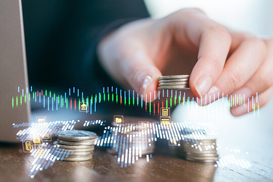 Coins stacked on a table as financial data charts appear with a hand sorting currency
