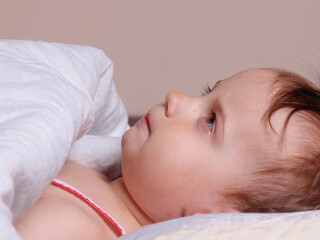 A child resting quietly before drifting into sleep.