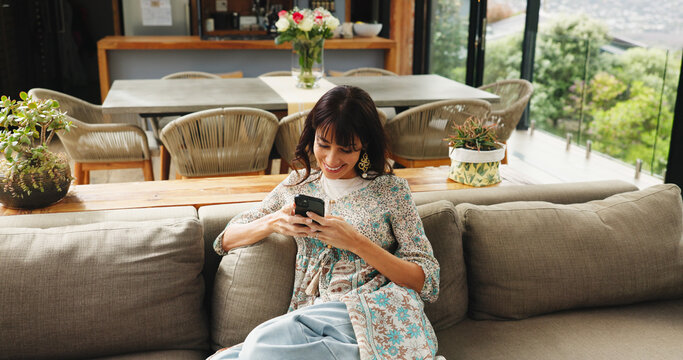 Above, woman and relax with phone at house for social media, browsing website and texting contact. Smile, person and mobile for communication, online notification and chat with message update