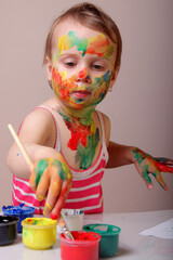 A little painter exploring colors with pure curiosity and joy.