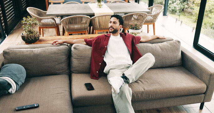 Break, relax and thinking with man on sofa in living room of home for me time or wellness. Chilling, high angle and idea with person in apartment for easy morning, inspiration or weekend planning