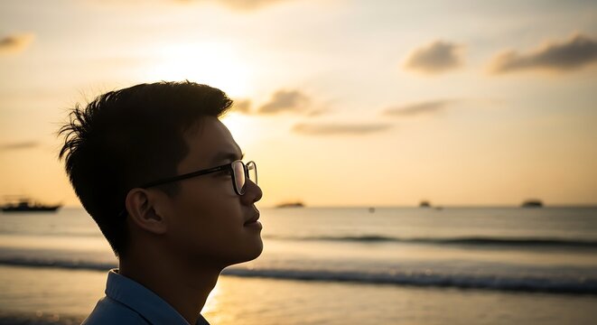Man Contemplating the Sunset at the Beach.