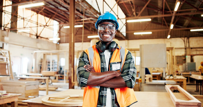 Carpentry, woodworking and portrait of black man in factory for furniture repair, restoration and confident. Carpenter, crossed arms and happy person in workshop for wood, lumber or timber production