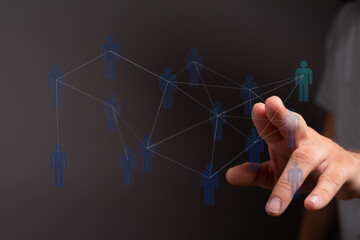 Hand touching digital interface, representing concept of connection, technology, networking, and social media.