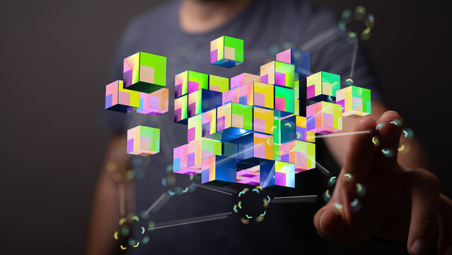 Digitally rendered image of a hand touching abstract colorful cubes. Representing technology, data, and future