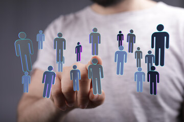 Hand pointing at floating digital figures representing people, teamwork, and networking, symbolizing collaborat