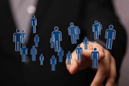 Hand touching digital people figures symbolizing connection, teamwork, and networking in a business and social - Powered by Adobe