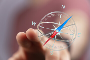 A hand holding a digital compass, offering a sense of direction, travel, and guidance. Perfect for...
