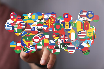 A hand touching a collection of world flags. Represents concepts such as globalization, international relations, and global unity. Perfect for c