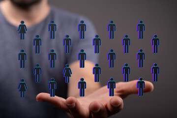 A hand holding a network of people icons, representing social connection, communication and...