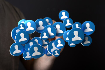 Abstract image showing a hand holding icons symbolizing people and connectivity. Perfect for...