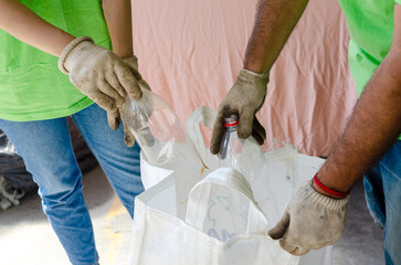 One man and one woman volunteers picking up plastic bottle.Recycle concept.Earth Day concept.