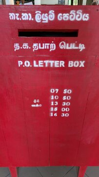 SIGIRIYA, SRI LANKA - NOVEMBER 2, 2025: Traditional red P.O. Letter Box with Sinhala, Tamil and English text and collection times, mail and communication concept in South Asia