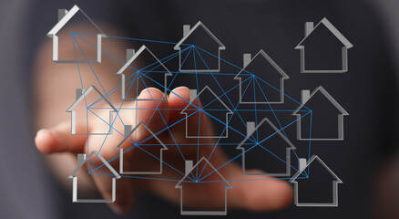 Conceptual image of a hand touching a network of interconnected house icons. Ideal for illustrating concepts of digital real estate, connected h