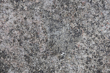 Rough, detailed texture background of an aging, monochromatic gray concrete floor, showcasing fine grains, natural imperfections, and a dusty surface. Ideal for wall texturing and abstract design.