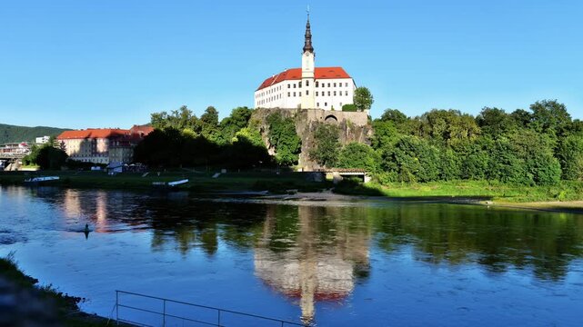 Panoramic view of the historic residence with Elbe River under a blue summer sky in northern Bohemia, Czechia