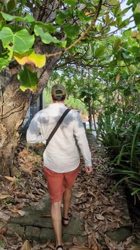 Exploration escape paradise happy man exploring tropical Sri Lanka jungle palm trail coastal beach shoreline island adventure bay walking vacation active traveling hat funny