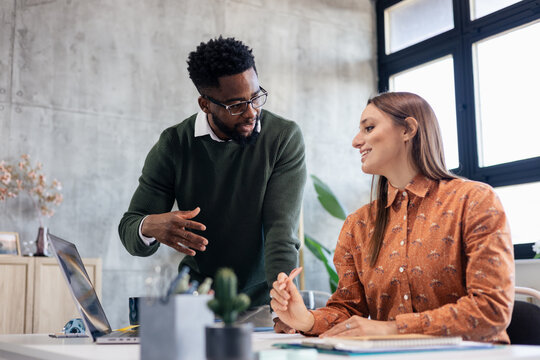 Business colleagues collaborating on project in modern office