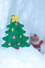 A vertical holiday scene featuring a handmade Christmas tree patch on glacial snow, with a distant blurred Santa joyfully peeking behind. A playful winter micro world perfect for festive designs.