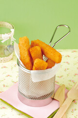 Cheese sticks coated in breadcrumbs. Food for a children's party.