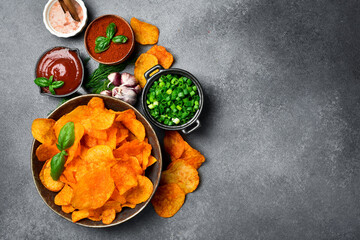 Paprika flavored potato chips in a ceramic bowl. Salty snacks for beer.