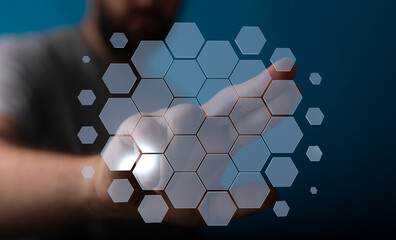A man's hand touching a hexagon grid interface representing technology, data and innovation. Suitable for busin