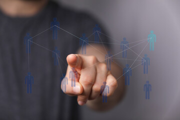 Hand touching digital interface representing human connections, social media, networking, global business, team