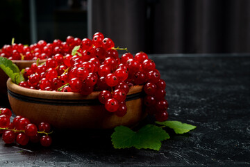 Organic Red currant berries in a bowl. Close-up, free space for text.