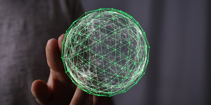 Close-up of hand holding a glowing digital network sphere, representing global connection, technology and innovation, with a focus on data and t