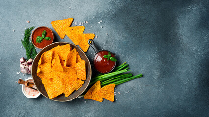 Crispy nachos chips with paprika in a bowl. Salty Mexican snacks.