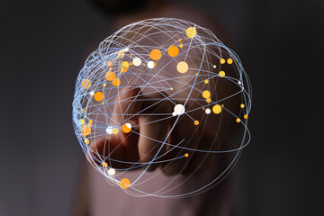 A person's finger touches a digital globe with interconnected nodes symbolizing global communication, networks, and innovative techno
