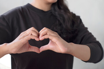 woman make hands love gesture