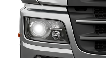 Close up view of a silver truck headlight and front grill with bright light on display background transparent 