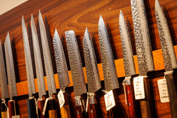 Display of Japanese Kitchen Knives on Wooden Wall