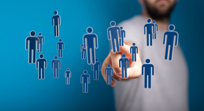 Digitally generated figures representing people with a human hand pointing towards them. Concept of social netw