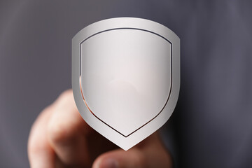 Hand holding a digital shield representing security, protection, and data privacy. Ideal for...