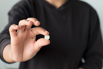 Person Holding Medication Pills in Hand Close-Up