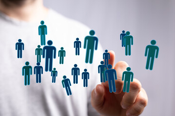 Hand reaching towards people icons representing human connection, networking, and social media concepts.