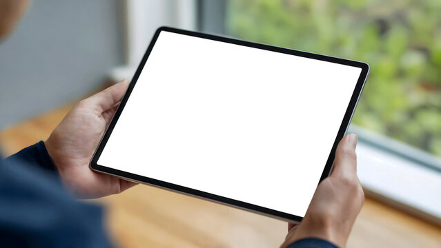 Person holding a tablet with a blank screen, perfect for showcasing digital content and modern business ideas.