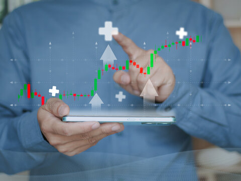 Businessman analyzing digital candlestick chart on mobile device, showing financial growth, market trends and data-driven investment strategies in modern trading environment.